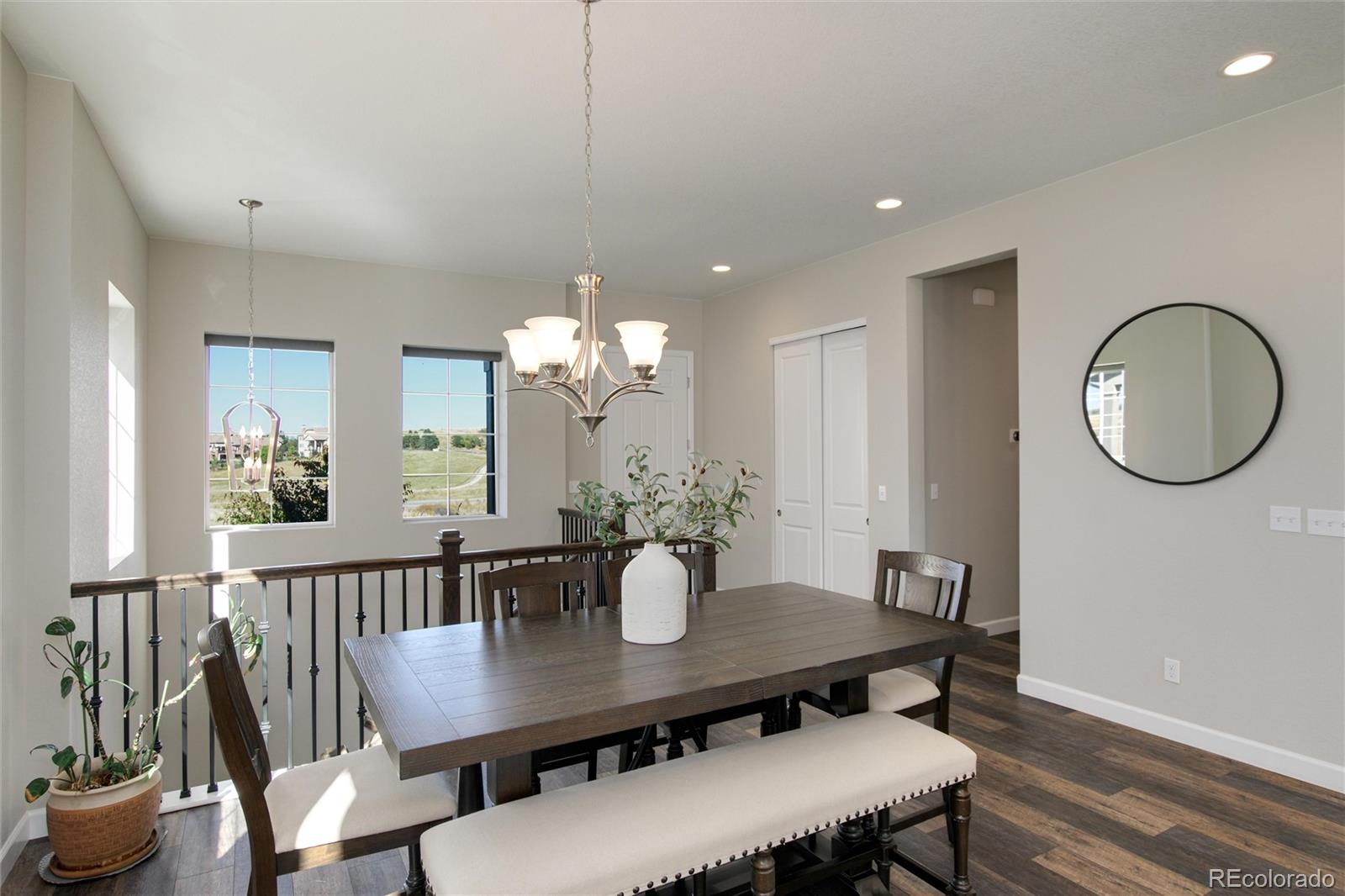 1165 Brocade Drive Highlands Ranch, CO 80126 - Photo 20 of 40 a view of a dining room with furniture a chandelier and wooden floor
