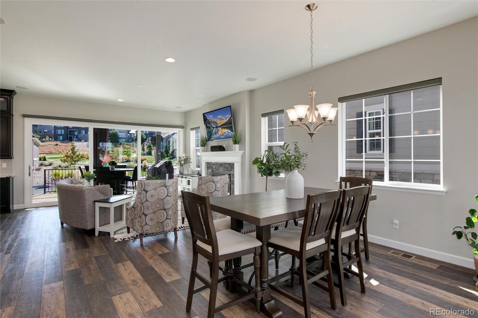 1165 Brocade Drive Highlands Ranch, CO 80126 - Photo 21 of 40 a view of a dining room with furniture window and wooden floor