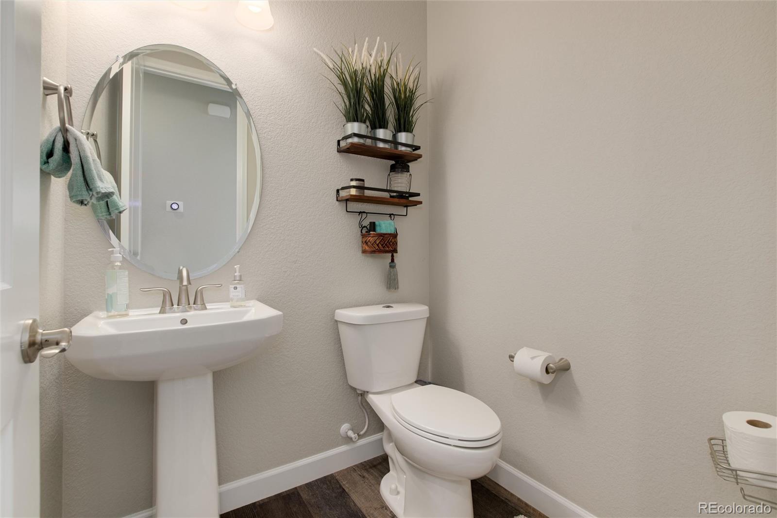 1165 Brocade Drive Highlands Ranch, CO 80126 - Photo 22 of 40 a bathroom with a sink a toilet and mirror