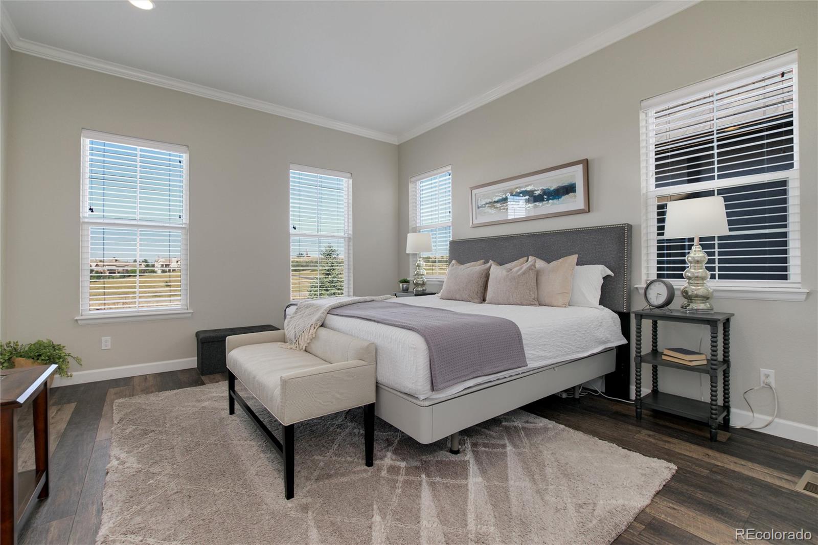 1165 Brocade Drive Highlands Ranch, CO 80126 - Photo 23 of 40 a bedroom with a bed and wooden floor