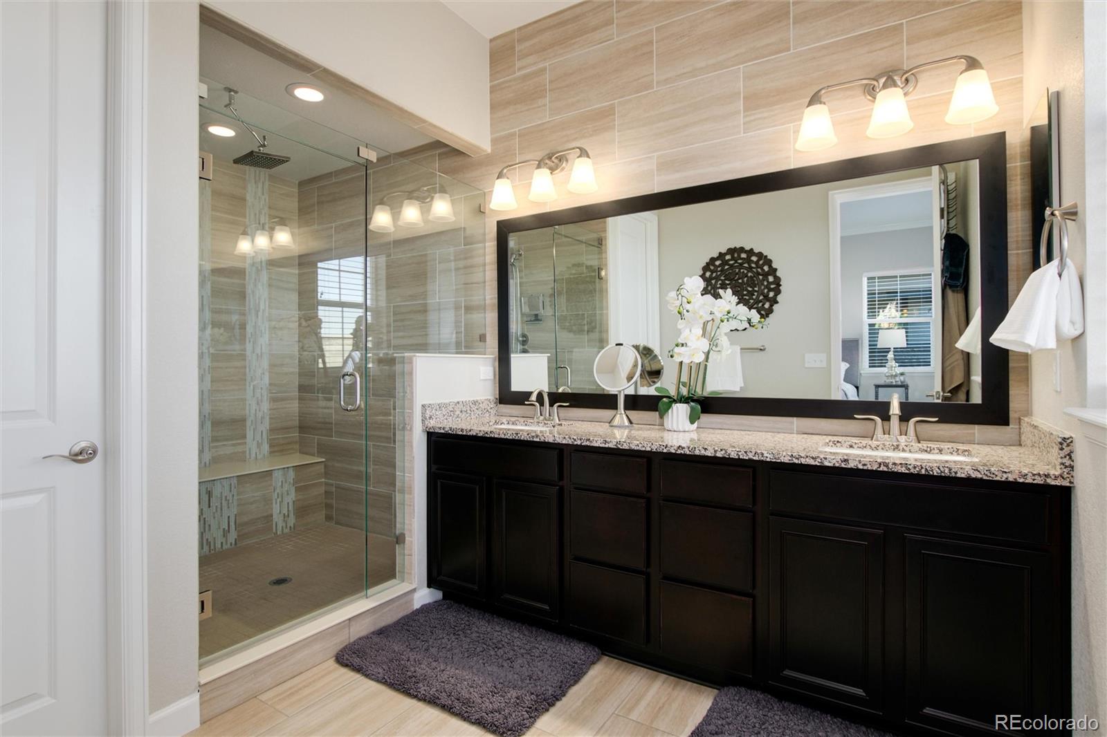 1165 Brocade Drive Highlands Ranch, CO 80126 - Photo 25 of 40 a bathroom with a double vanity sink mirror and shower