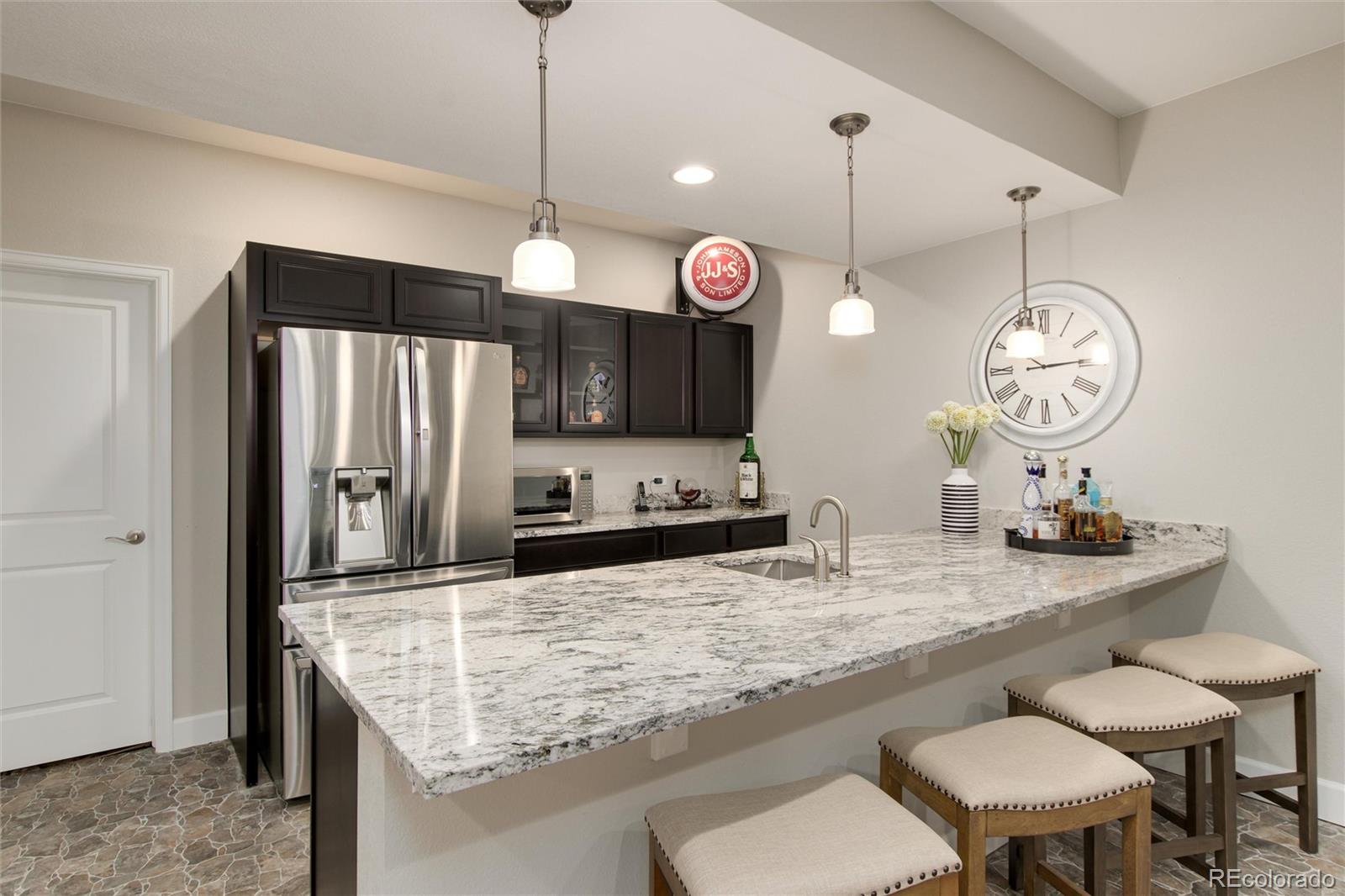 1165 Brocade Drive Highlands Ranch, CO 80126 - Photo 30 of 40 a kitchen with stainless steel appliances granite countertop a sink a stove and a refrigerator