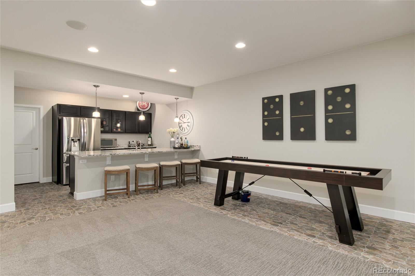 1165 Brocade Drive Highlands Ranch, CO 80126 - Photo 31 of 40 a room with furniture a rug and white walls