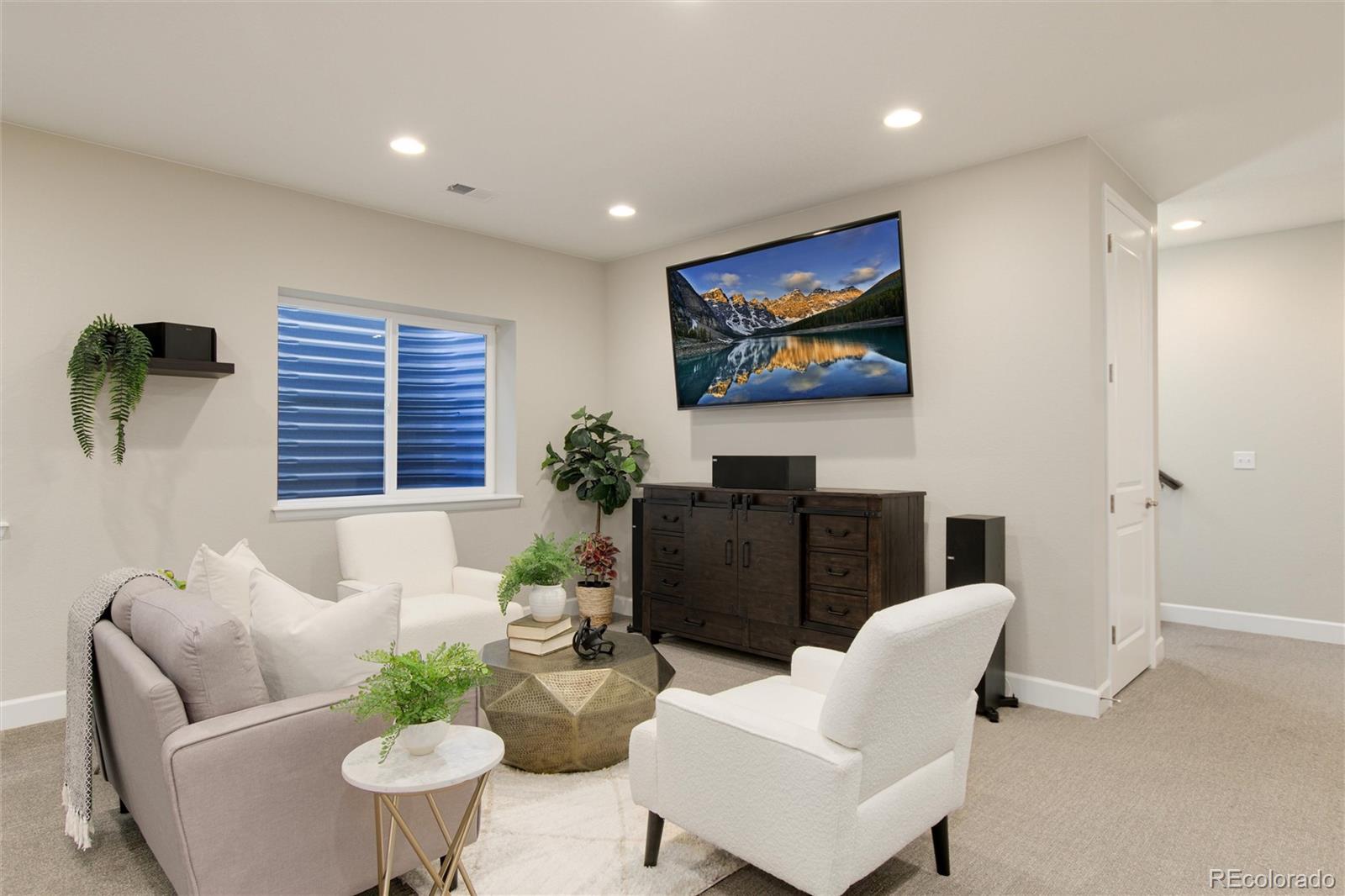 1165 Brocade Drive Highlands Ranch, CO 80126 - Photo 33 of 40 a living room with furniture and a flat screen tv