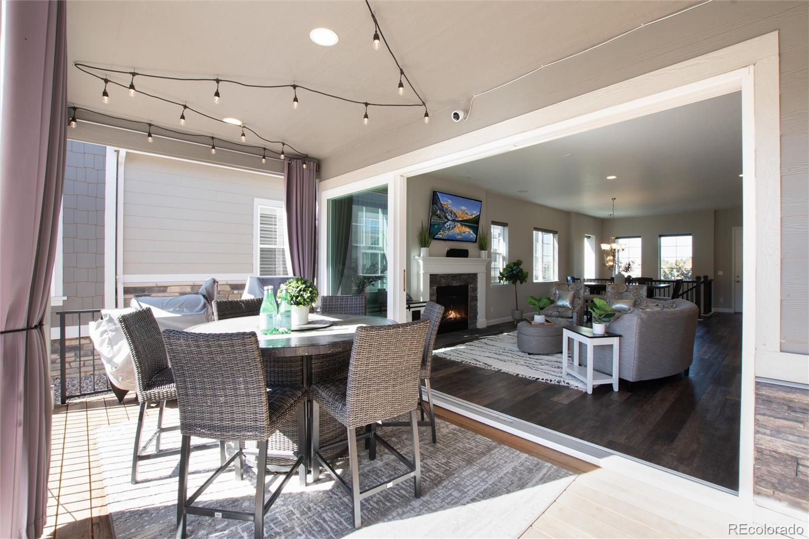 1165 Brocade Drive Highlands Ranch, CO 80126 - Photo 35 of 40 a dining room with furniture a rug and wooden floor