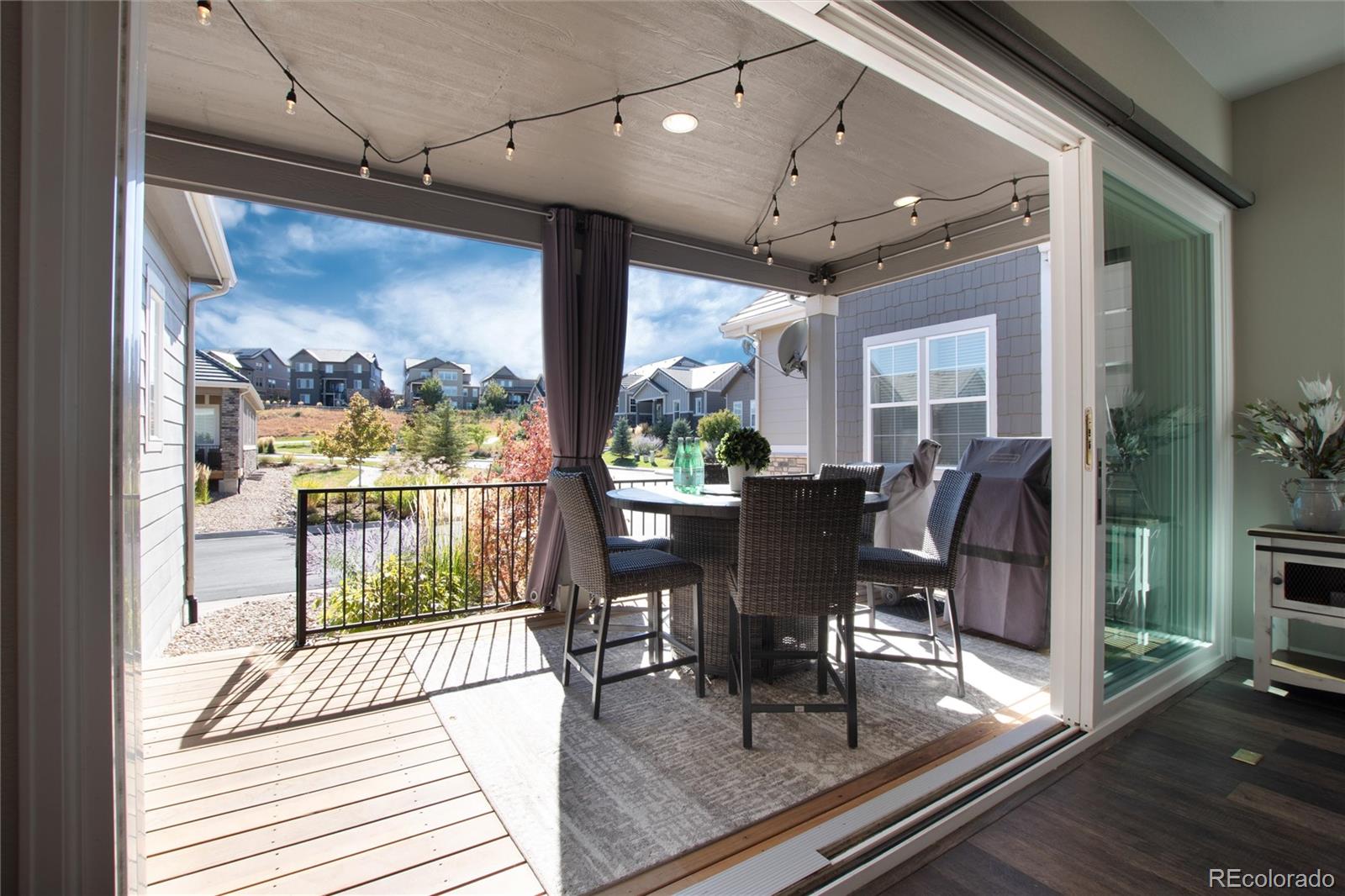 1165 Brocade Drive Highlands Ranch, CO 80126 - Photo 36 of 40 a view of a dining room with furniture a chandelier and wooden floor