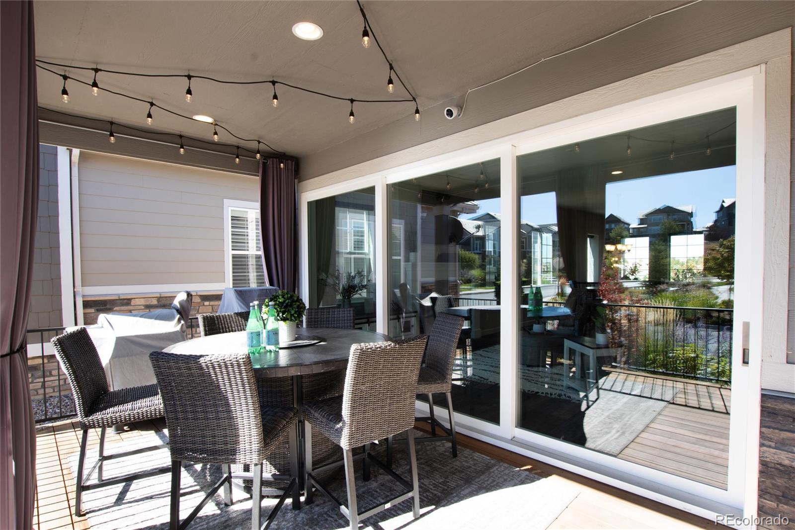 1165 Brocade Drive Highlands Ranch, CO 80126 - Photo 38 of 40 a view of a dining room with furniture wooden floor and floor to ceiling window