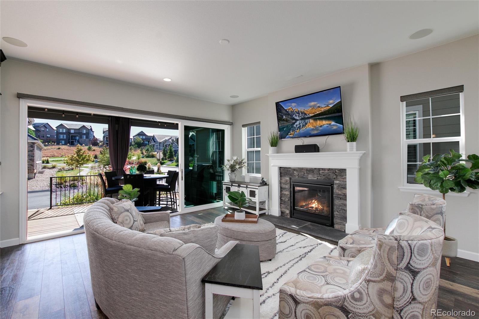 1165 Brocade Drive Highlands Ranch, CO 80126 - Photo 7 of 40 a living room with furniture a fireplace and a large window