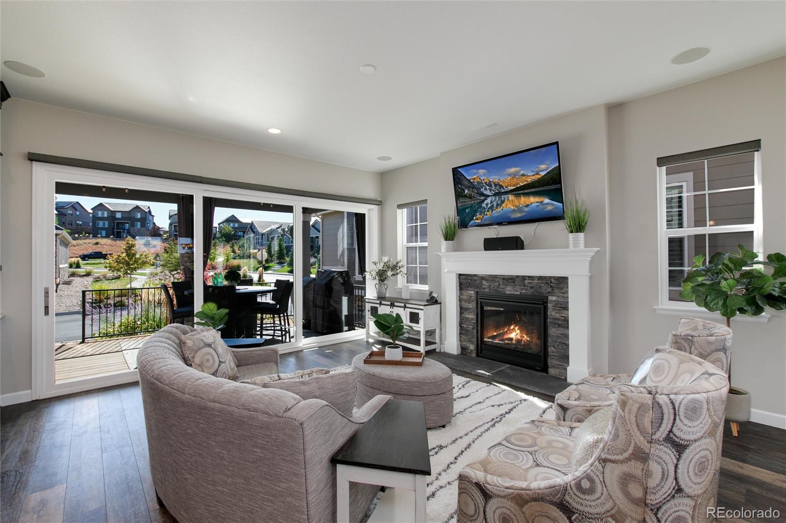 1165 Brocade Drive Highlands Ranch, CO 80126 - Photo 8 of 40 a living room with furniture a fireplace and a large window