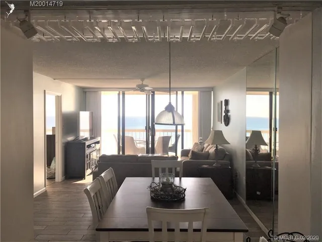 a view of a dining room with furniture large window and chandelier