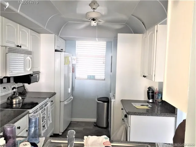 a kitchen with sink refrigerator and stove