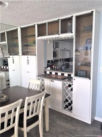 a kitchen with a table chairs and a wooden floor
