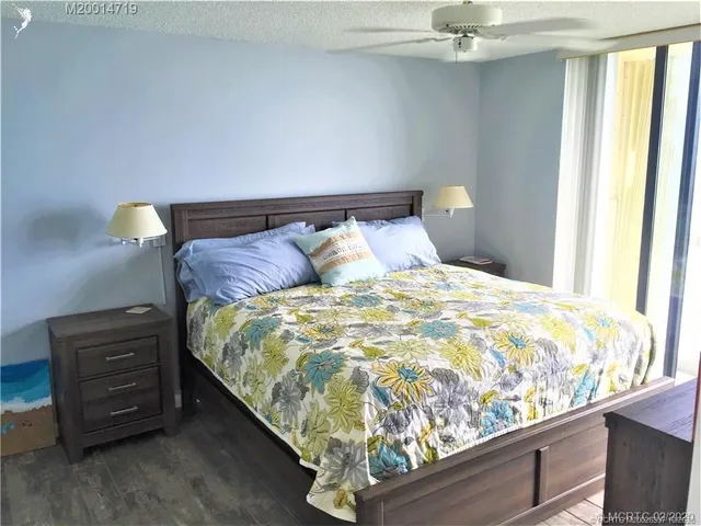 a bed sitting in a bedroom next to a window with dresser