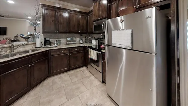 a white refrigerator freezer sitting inside of a kitchen