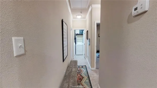 view of a hallway with wooden floor and a livingroom