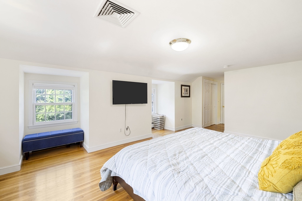 3 Hadley Road Lexington, MA 02420 - Photo 14 of 30 a bedroom with a bed and a flat screen tv