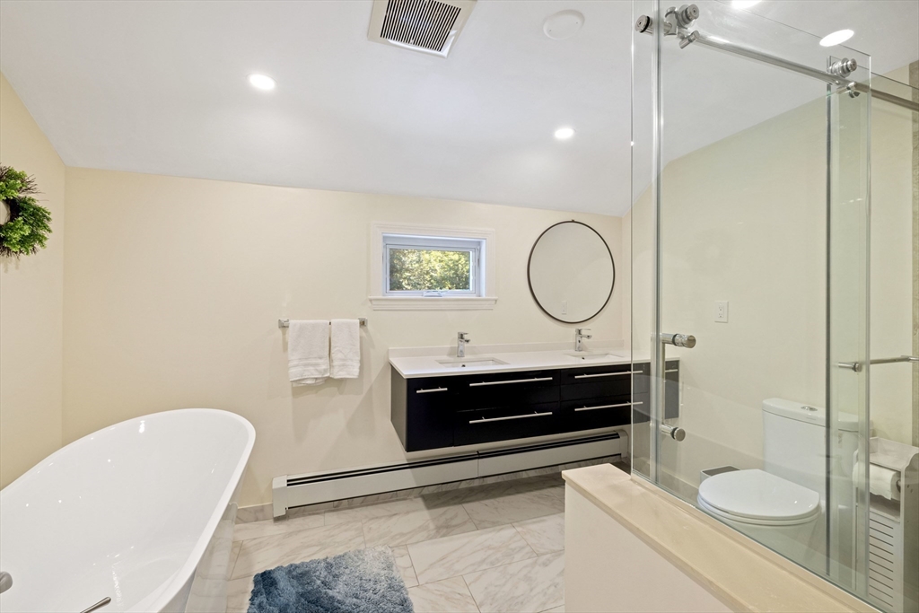 3 Hadley Road Lexington, MA 02420 - Photo 16 of 30 a bathroom with a toilet a sink and a mirror