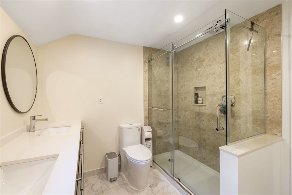 3 Hadley Road Lexington, MA 02420 - Photo 17 of 30 a bathroom with a shower a sink a toilet and a mirror