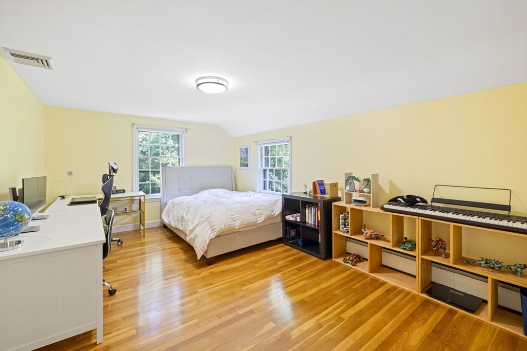 3 Hadley Road Lexington, MA 02420 - Photo 18 of 30 a bedroom with a bed and dresser with wooden floor