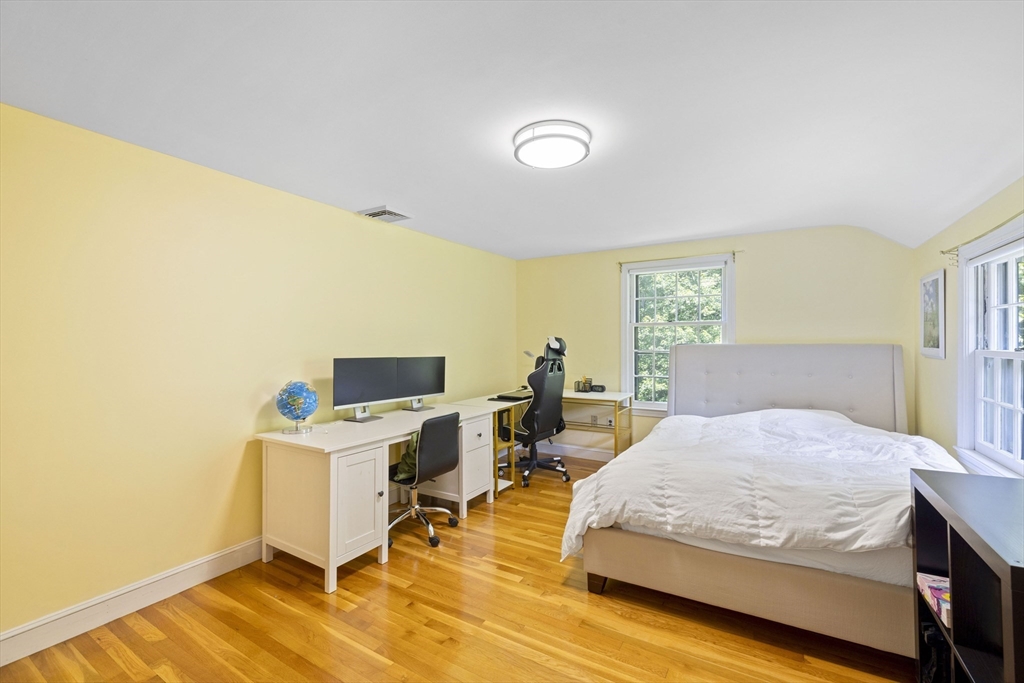 3 Hadley Road Lexington, MA 02420 - Photo 19 of 30 a bedroom with a bed and a table in it