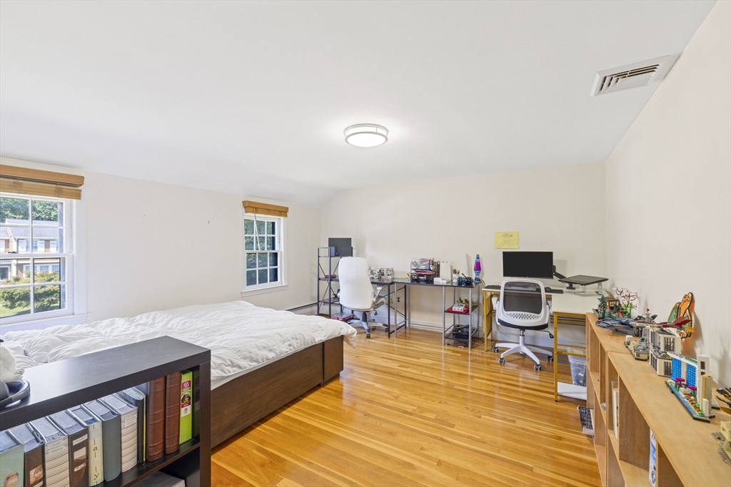 3 Hadley Road Lexington, MA 02420 - Photo 21 of 30 a bedroom with a bed and a wooden floor