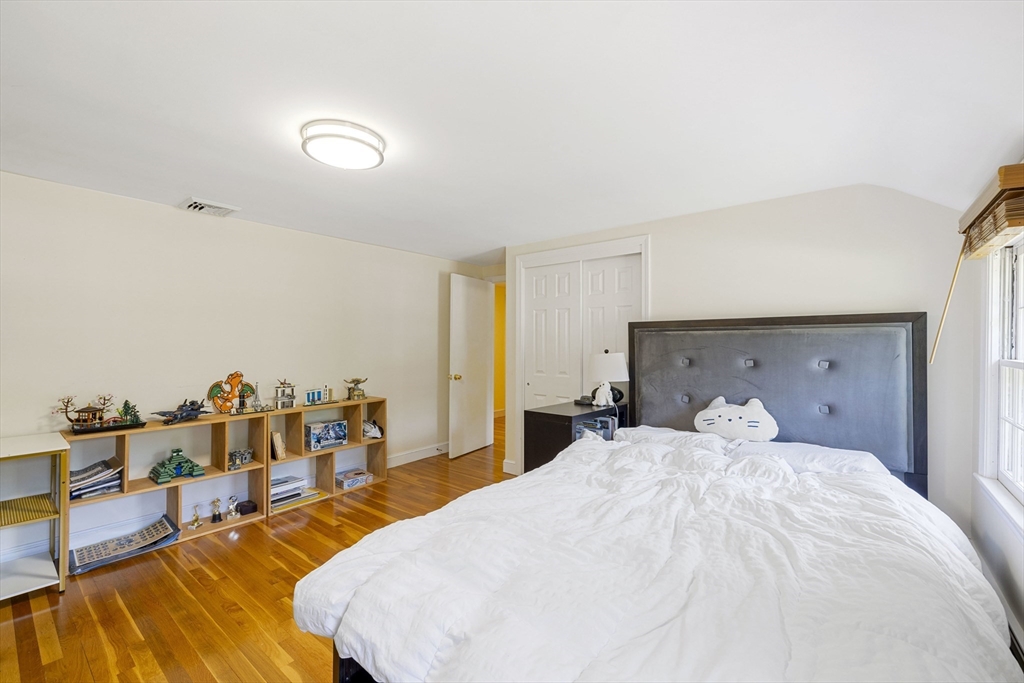 3 Hadley Road Lexington, MA 02420 - Photo 22 of 30 a bed room with a bed and a couch