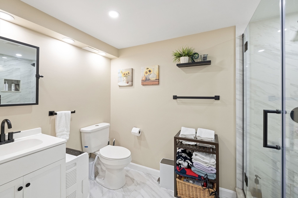 3 Hadley Road Lexington, MA 02420 - Photo 27 of 30 a bathroom with a toilet a sink and a mirror