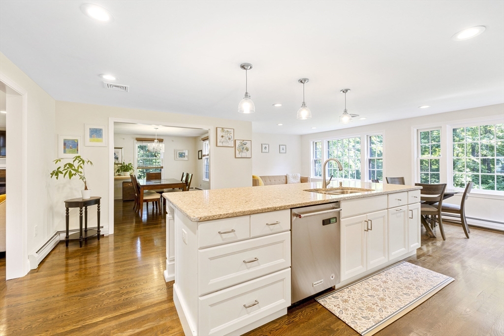 3 Hadley Road Lexington, MA 02420 - Photo 4 of 30 a open kitchen with granite countertop a stove a sink and a dining table with wooden floor
