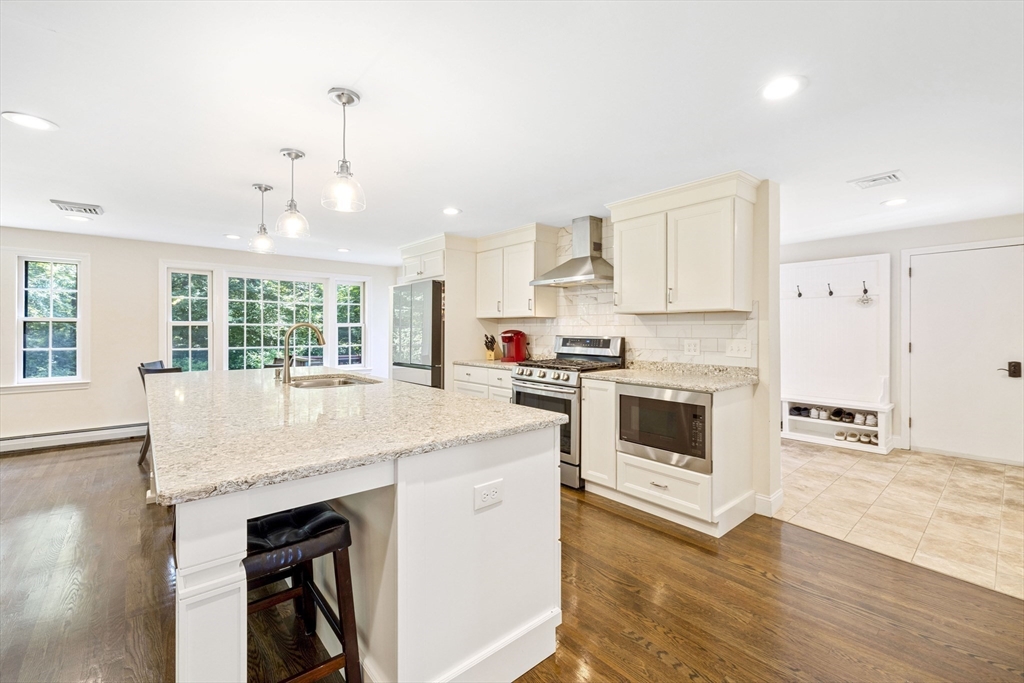 3 Hadley Road Lexington, MA 02420 - Photo 7 of 30 a kitchen with granite countertop a stove a sink and a refrigerator