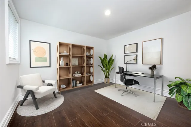 a living room with furniture a rug and a potted plant