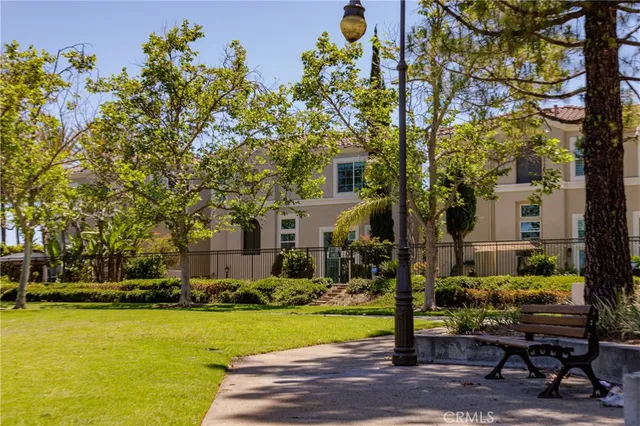 a front view of a house with swimming pool and trees
