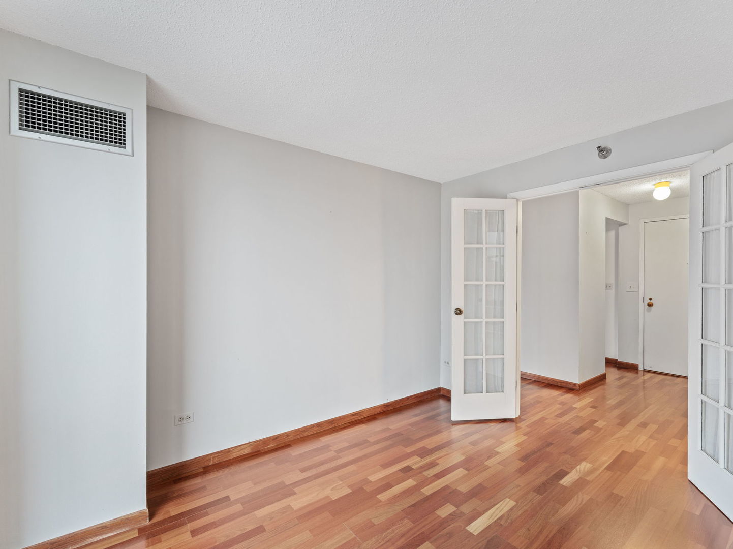 111 West Maple Street, Unit 1401 Chicago, IL 60610 - Photo 14 of 22 a view of empty room with wooden floor