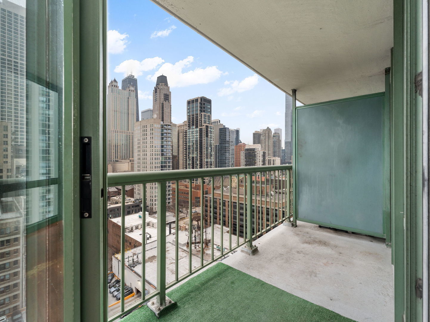 111 West Maple Street, Unit 1401 Chicago, IL 60610 - Photo 8 of 22 a view of a city from a balcony