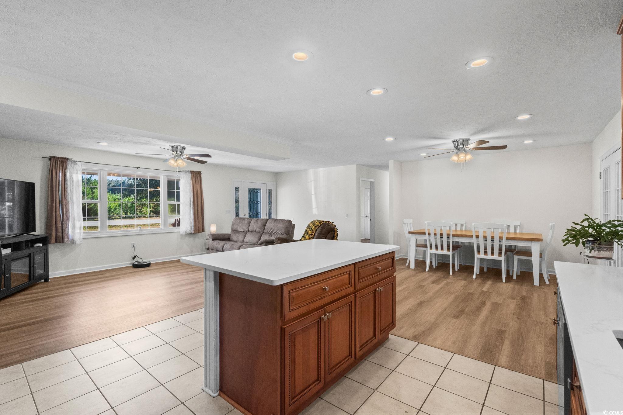 1996 Heritage Road Loris, SC 29569 - Photo 13 of 40 Kitchen with ceiling fan, light tile patterned floors, brown cabinets, recessed lighting, and a textured ceiling