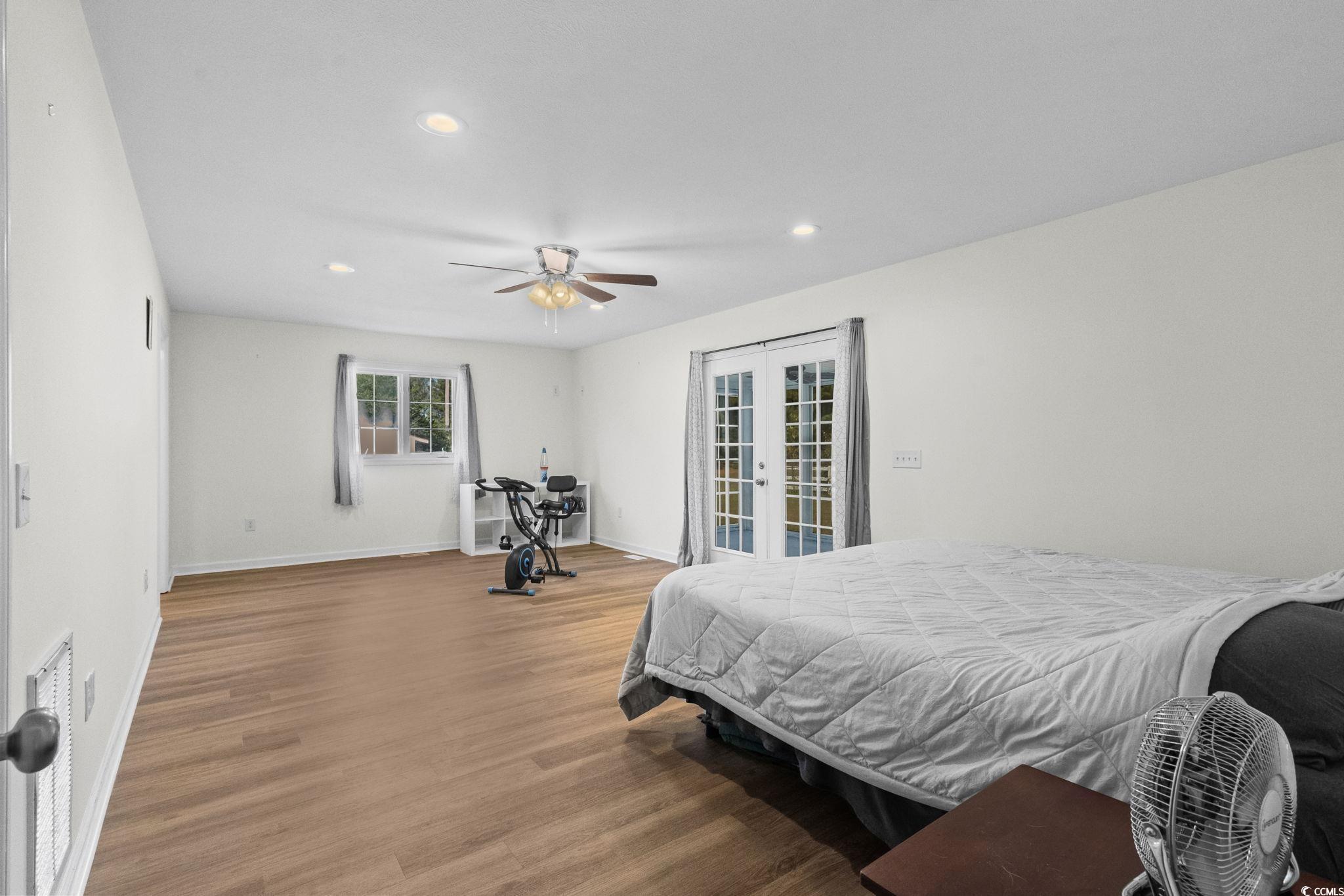 1996 Heritage Road Loris, SC 29569 - Photo 17 of 40 Bedroom with french doors, wood finished floors, recessed lighting, access to outside, and ceiling fan