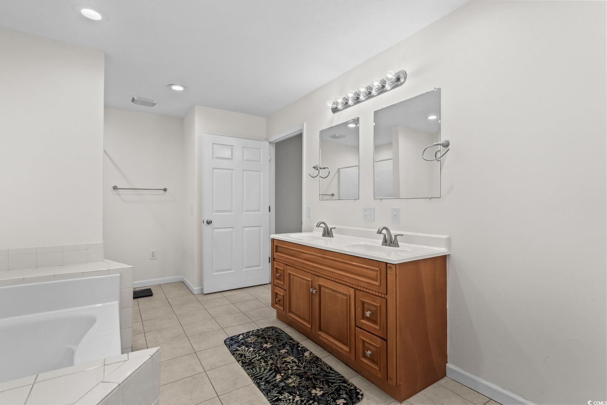 1996 Heritage Road Loris, SC 29569 - Photo 19 of 40 Full bath featuring light tile patterned floors, double vanity, recessed lighting, and a tub