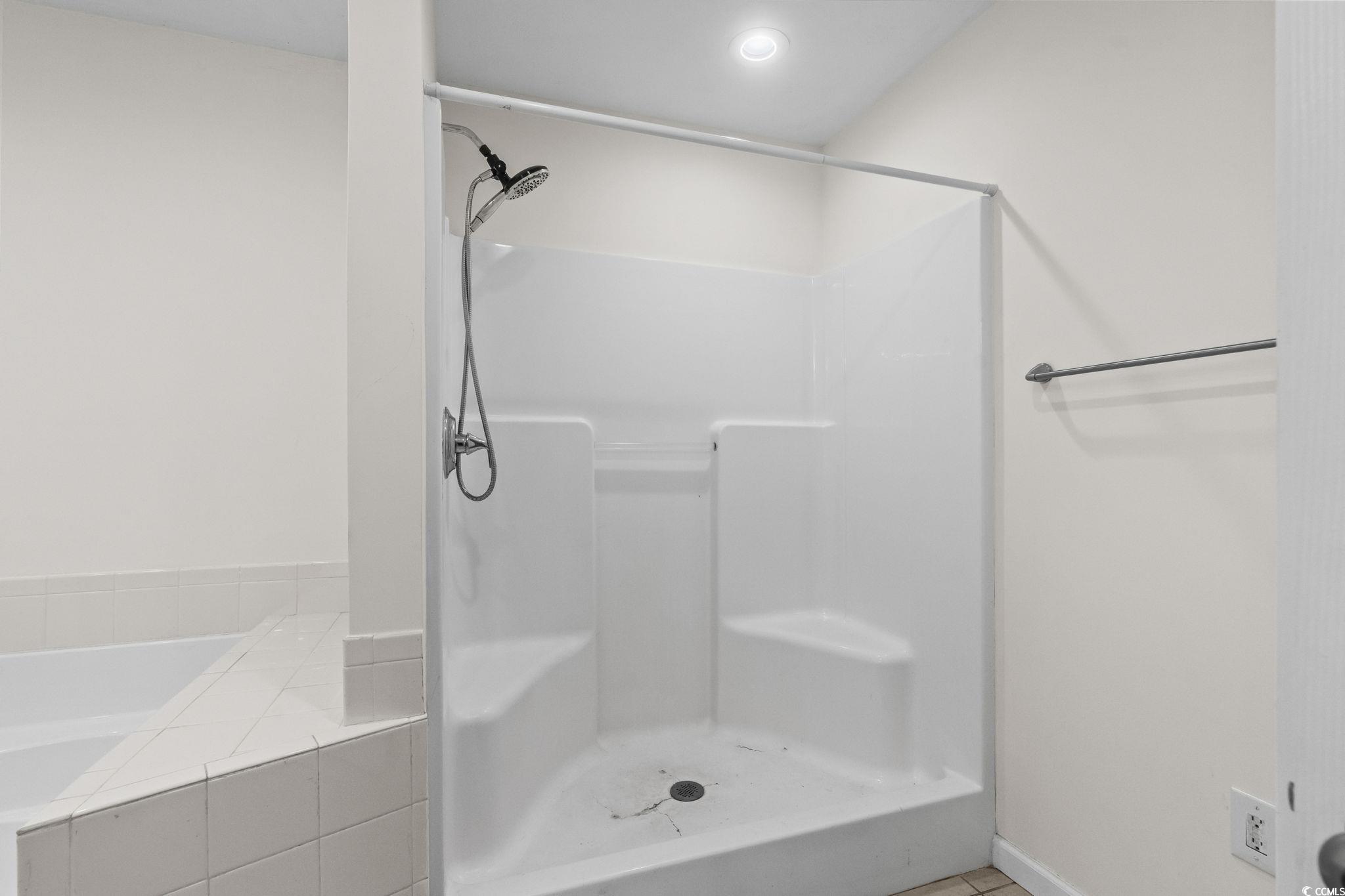 1996 Heritage Road Loris, SC 29569 - Photo 20 of 40 Full bathroom with light tile patterned flooring, a garden tub, and a shower stall