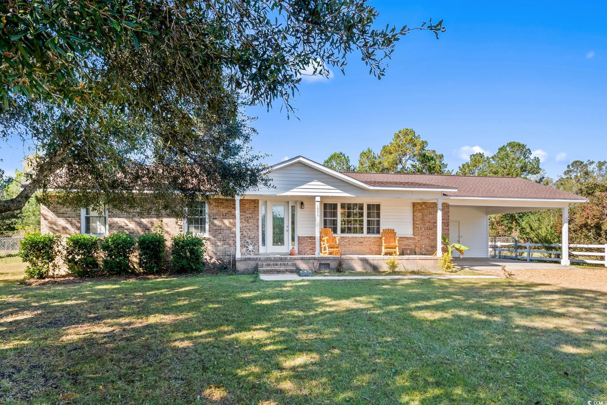 1996 Heritage Road Loris, SC 29569 - Photo 2 of 40 Ranch-style house with brick siding, covered porch, and an attached carport