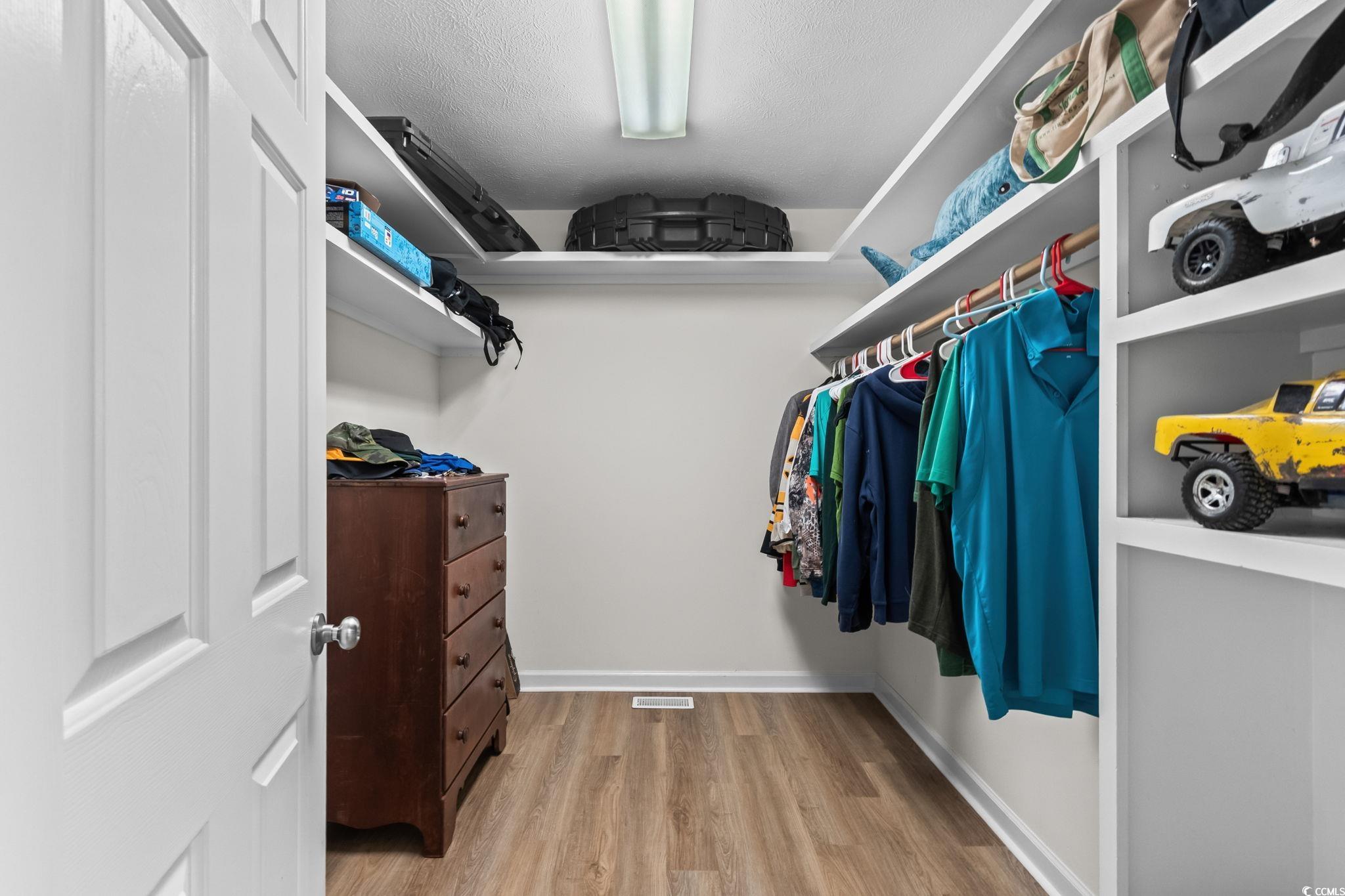 1996 Heritage Road Loris, SC 29569 - Photo 21 of 40 Walk in closet featuring light wood-type flooring