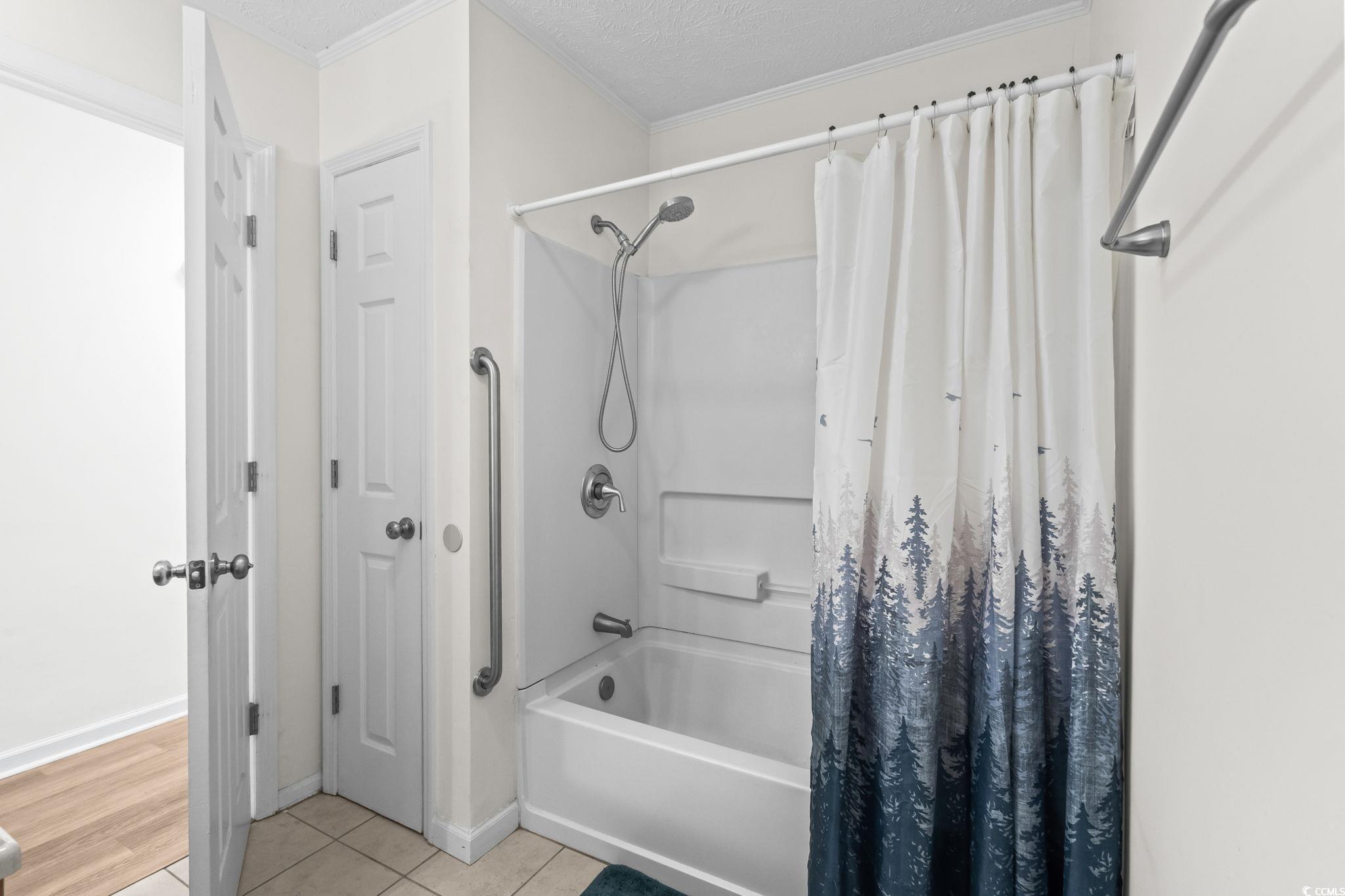 1996 Heritage Road Loris, SC 29569 - Photo 27 of 40 Bathroom with shower / bath combo, crown molding, light tile patterned floors, and a textured ceiling