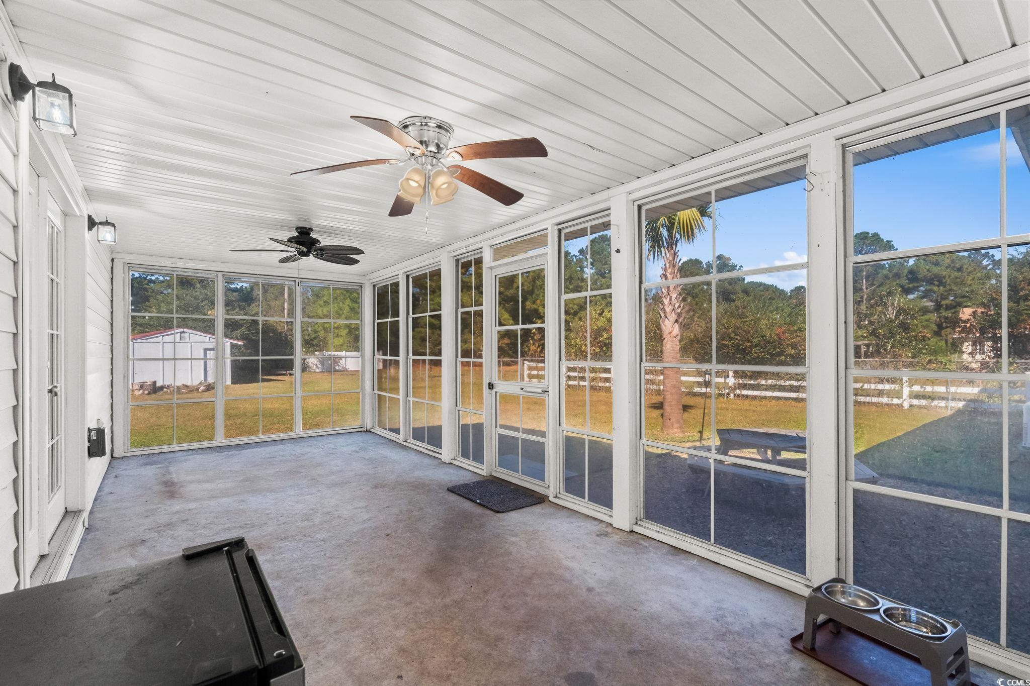 1996 Heritage Road Loris, SC 29569 - Photo 28 of 40 Unfurnished sunroom featuring view of wooded area and ceiling fan