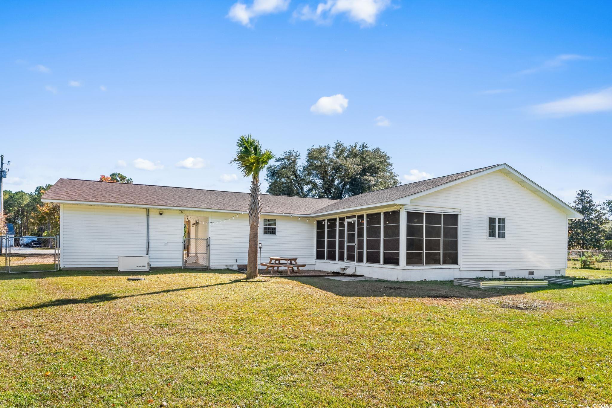 1996 Heritage Road Loris, SC 29569 - Photo 34 of 40 Back of house featuring crawl space, a patio, and a sunroom