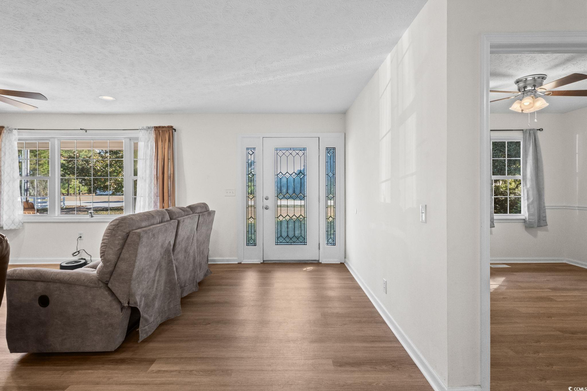 1996 Heritage Road Loris, SC 29569 - Photo 5 of 40 Foyer entrance with a ceiling fan, wood finished floors, and a textured ceiling