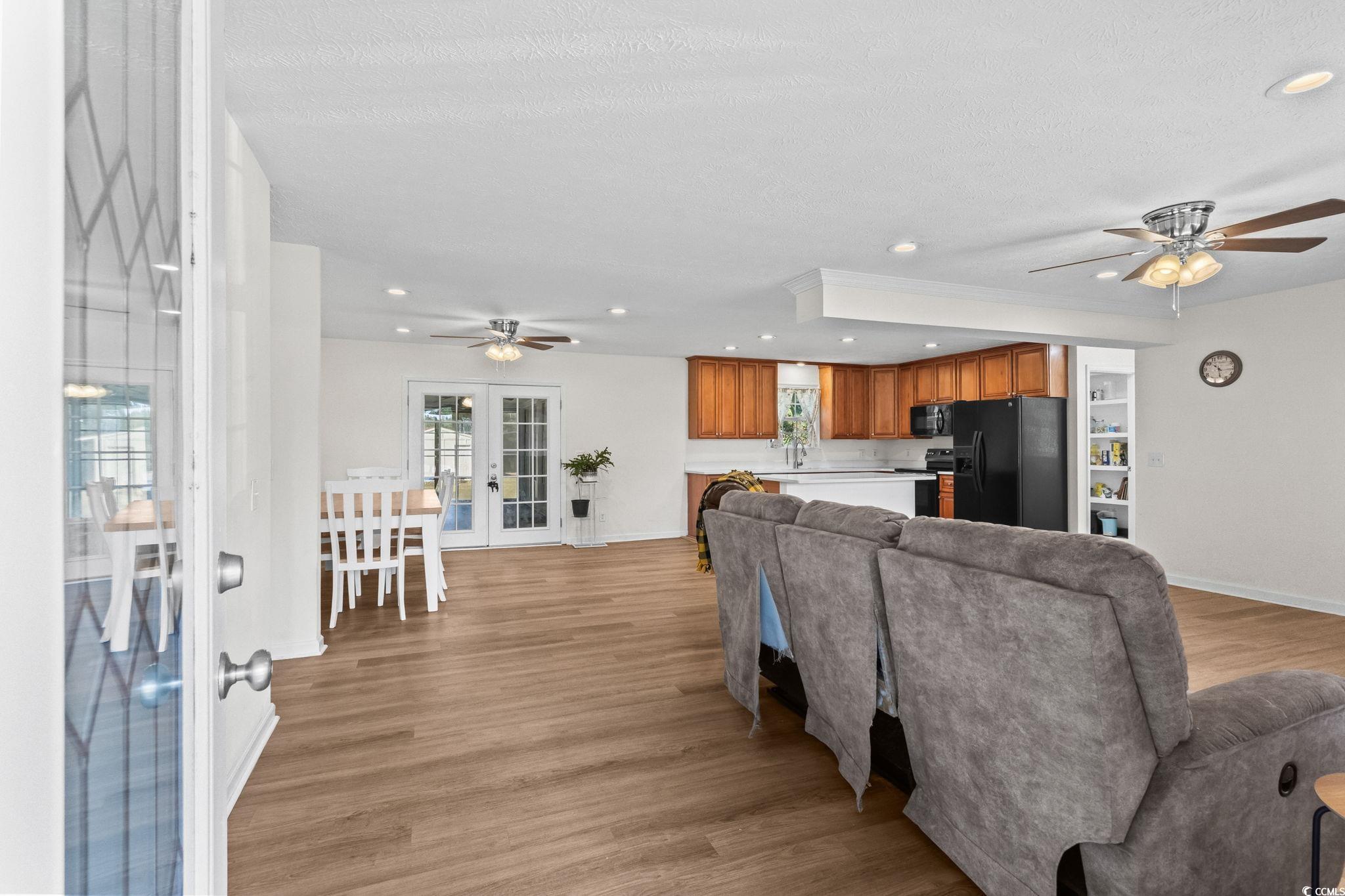 1996 Heritage Road Loris, SC 29569 - Photo 6 of 40 Living area featuring a ceiling fan, recessed lighting, light wood finished floors, french doors, and a textured ceiling