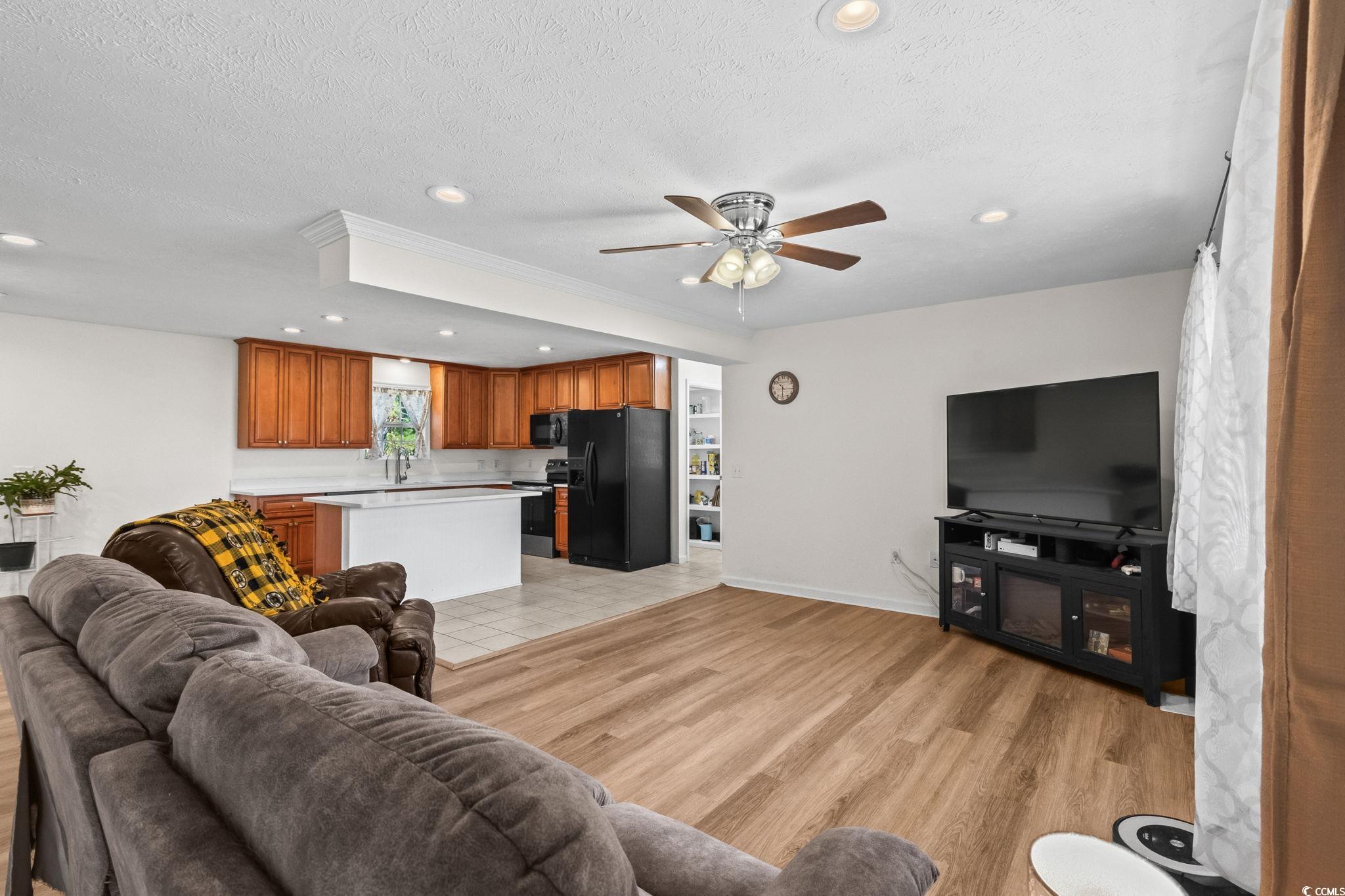 1996 Heritage Road Loris, SC 29569 - Photo 7 of 40 Living room featuring a textured ceiling, recessed lighting, ceiling fan, and light wood-type flooring