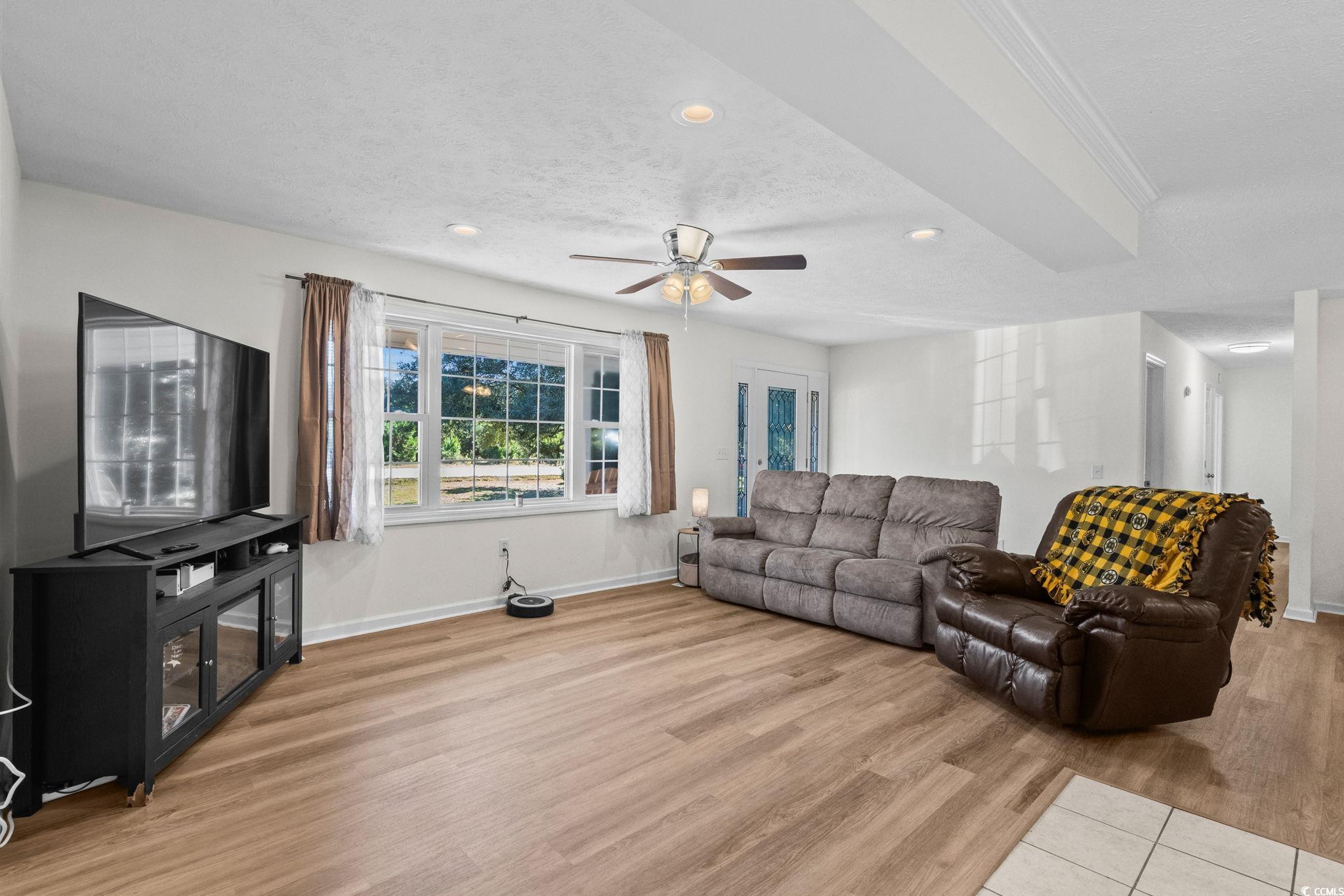 1996 Heritage Road Loris, SC 29569 - Photo 9 of 40 Living room featuring a textured ceiling, recessed lighting, light wood-type flooring, and a ceiling fan