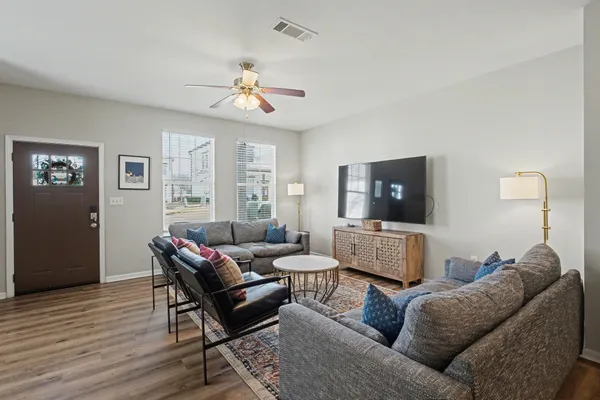 a living room with furniture and a flat screen tv