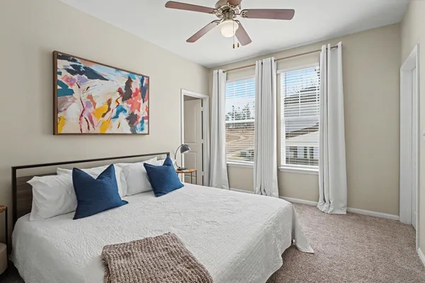 a bedroom with a bed and a painting on the wall