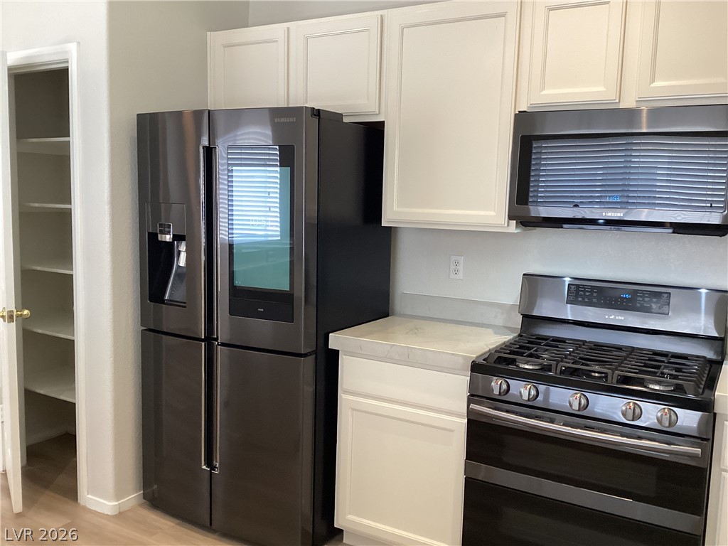 2135 Hidden Ranch Terrace Henderson, NV 89052 - Photo 4 of 27 Culinary delights await in this modern kitchen with stainless steel appliances and abundant storage.
