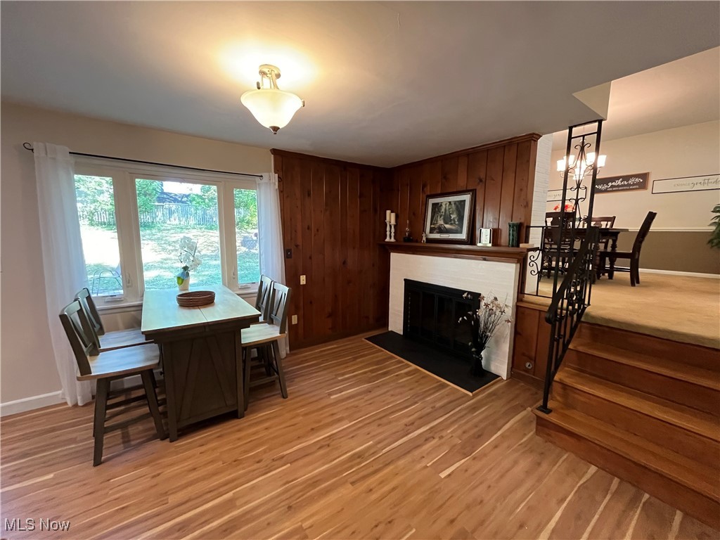 2079 Wyndham Road Akron, OH 44313 - Photo 14 of 35 Eat-in Kitchen featuring a fireplace, light floors, and view of expansive back yard with stairs leading to formal dining room
